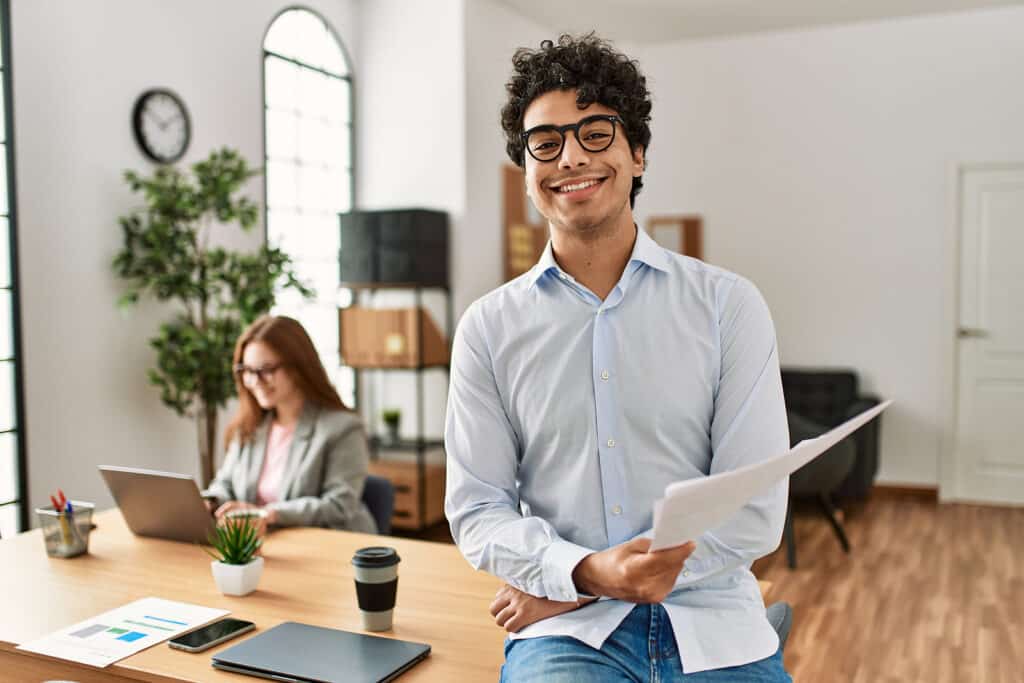 Business manager smiling happy and confident. Employee working a